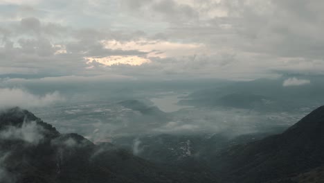 Drone-aerial-over-the-clouds,-view-of-lake-Amatitlan-and-mountains-in-Guatemala