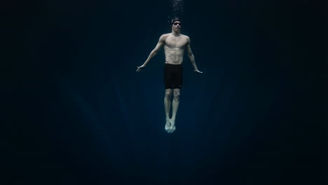 man floating serenely underwater