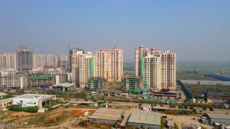 aerial drone shot capturing a massive high rise construction site in noida india