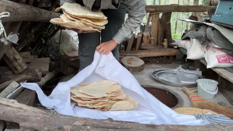 hot fresh bread in bundle white cloth textile round circle cylinder clay old oven wood fire burn fresh tasty healthy bread food cuisine persian culinary curly hair girl woman life freedom work rural