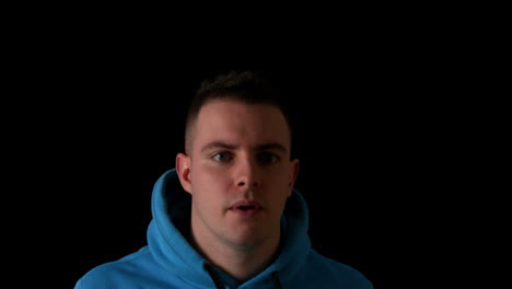 sporty young man jogging on black background