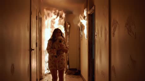 A woman in nightwear escapes a raging fire in a dimly lit hallway, desperately navigating through smoke and flames while holding a small dog for safety
