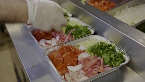 packing salad for delivery boxes in a restaurant