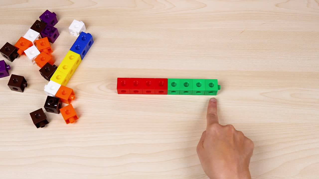 la mano interactúa con cubos de enlace coloridos en la mesa