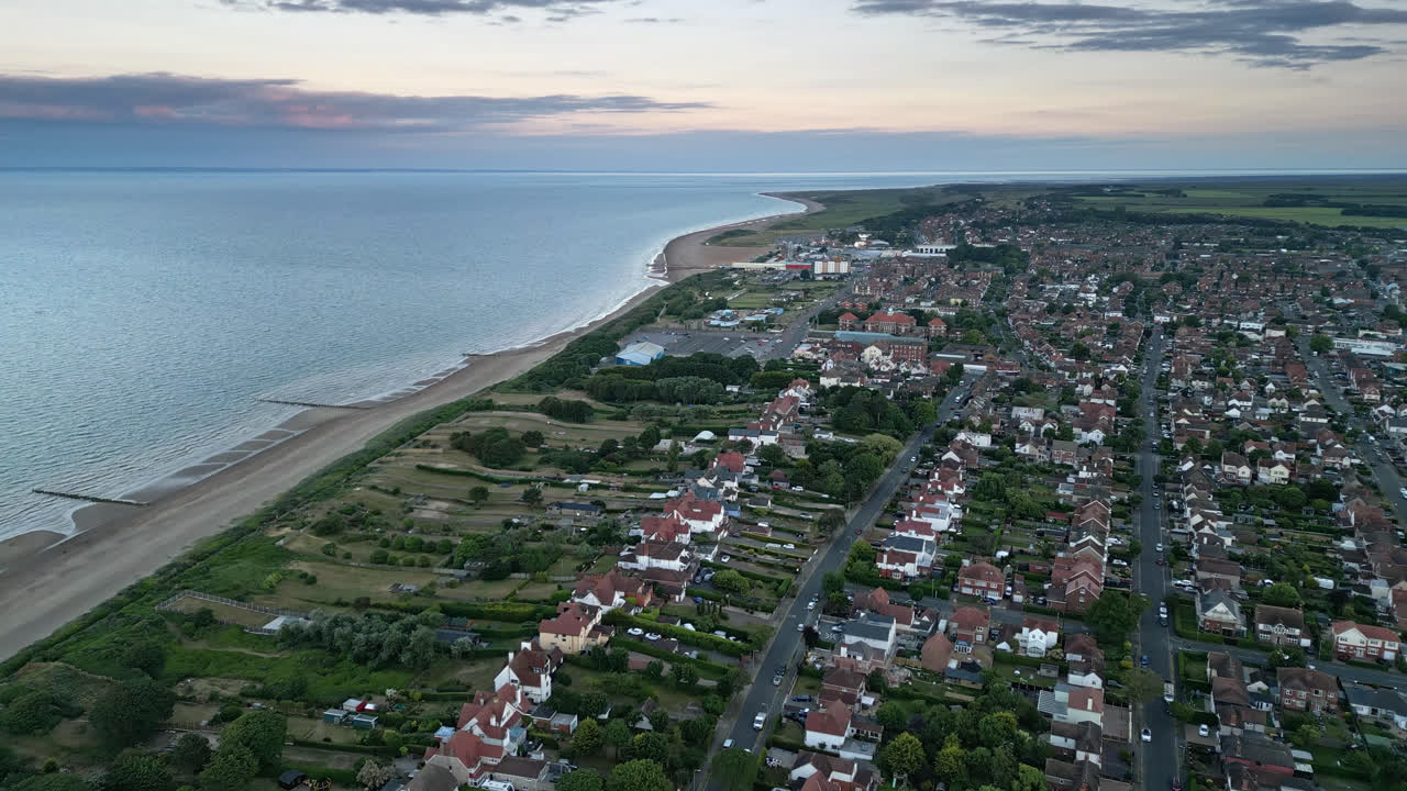 A summer holiday destination that's perfect for couples, families, and solo travelers alike is captured in a sunset scene over Skegness