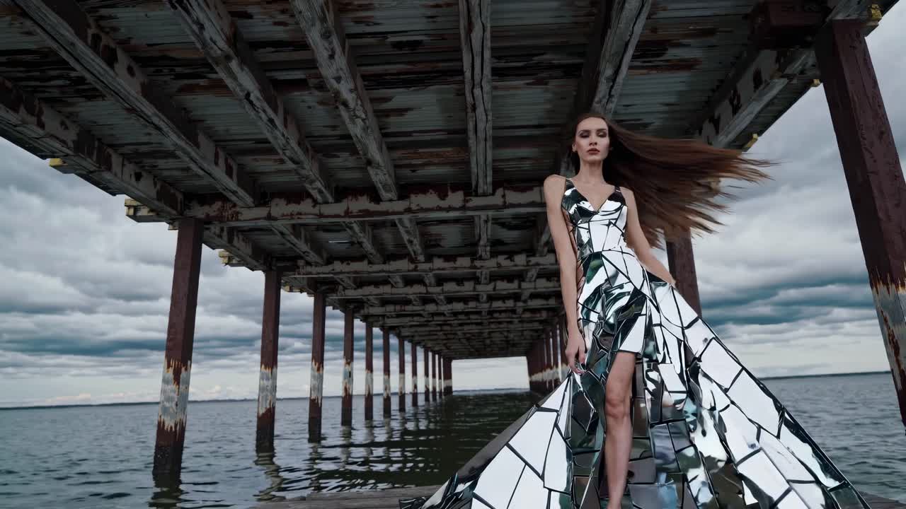 Woman in a Mirror Dress on a Pier