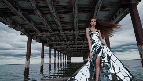 woman in a mirror dress on a pier