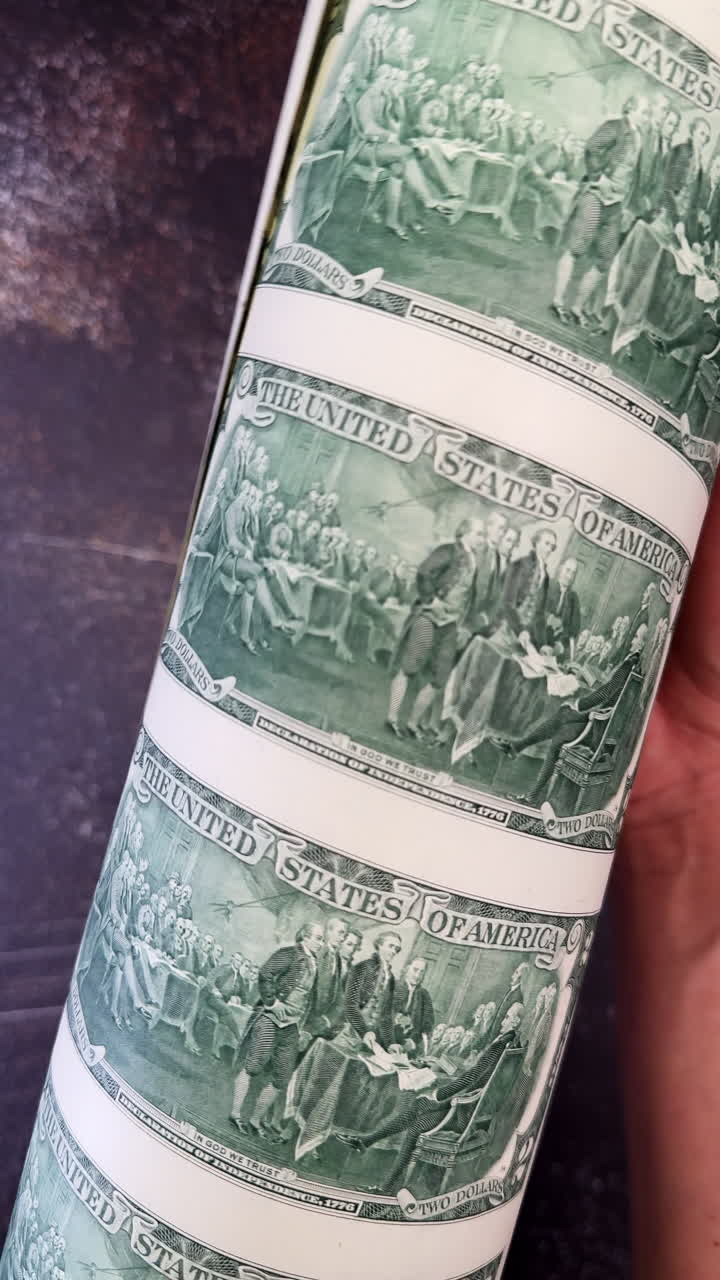Uncut two dollar bills sheet with reverse side up. Close up. Finance concept. Vertical video