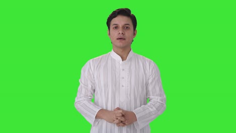 serious indian man talking to someone green screen