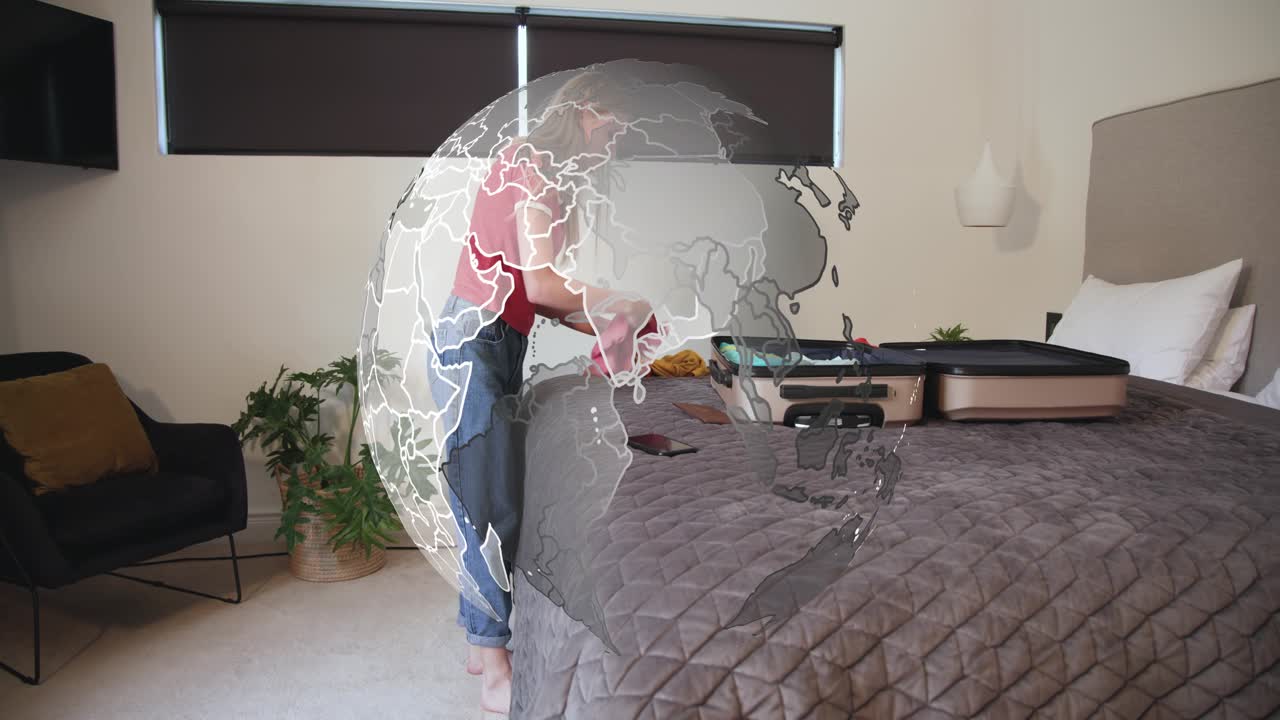 Woman placing light-green toiletry bag and opening it, packing case for travel under rotating globe