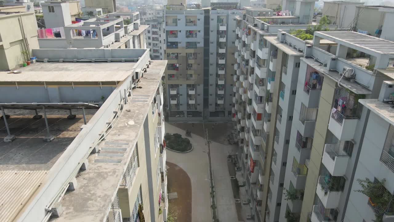 City walking path in tilting up view revealing city skyline, aerial drone