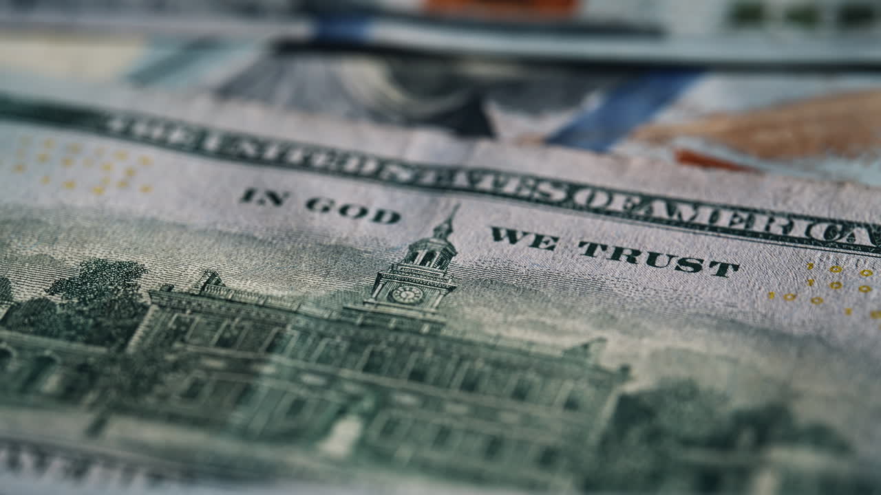 Macro view hundred dollars bills scattered on table surface. Back side 100 bill