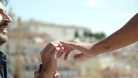 Side-view-of-gay-putting-engagement-ring-on-boyfriend's-finger