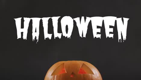 Animation-of-halloween-text-over-carved-pumpkin-on-black-background
