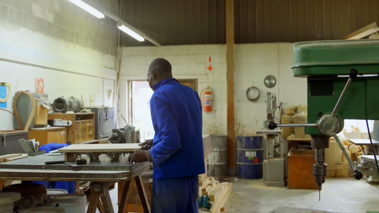 Worker working at table in workshop 4k