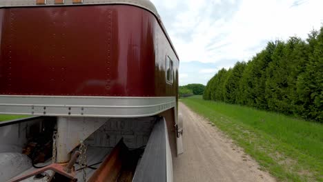 Pulling-gooseneck-horse-trailer-with-pickup-truck-in-reverse-gear,-back-view