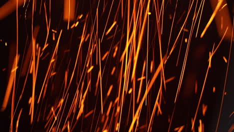 long shining sparkles flying in changing direction. beautiful bright scintilla moving quickly at black backdrop.