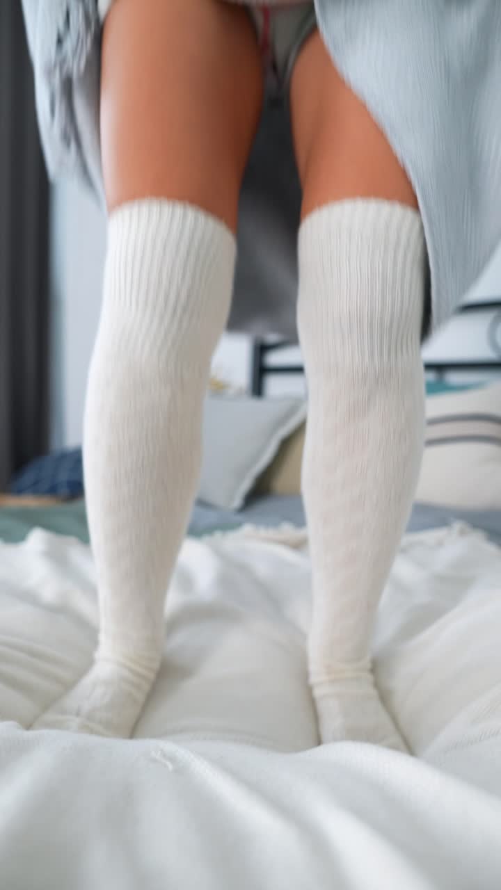 Woman Relaxing and Jumping on Bed