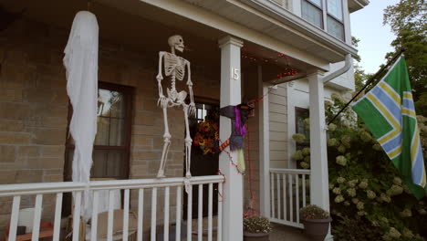 Boom-Por-El-Costado-De-Una-Casa-De-Dos-Pisos-En-Los-Suburbios-Para-Revelar-Decoraciones-De-Halloween-En-El-Porche-Delantero-Y-Una-Bandera.