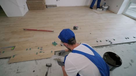construction, renovation, repair apartment. installing ceramic floor tiles - measuring and cutting the pieces. cuts tile. tile cutting