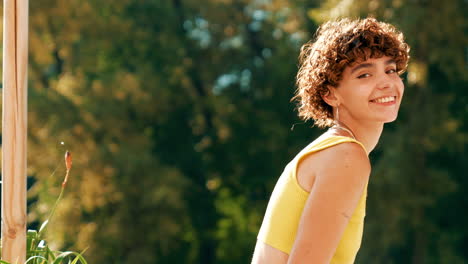 smiling woman in a yellow top outdoors