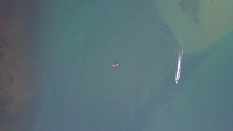 Aerial-top-down-view-of-Fraser-river-at-Harrison-Mills-with-an-anchored-boat-in-the-middle-of-the-river-and-another-passing-by