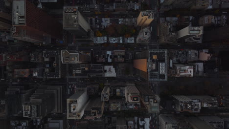 Aerial-birds-eye-overhead-top-down-panning-view-of-modern-high-rise-apartment-or-office-buildings-in-city.-Built-up-blocks-lined-by-roads.-Manhattan,-New-York-City,-USA