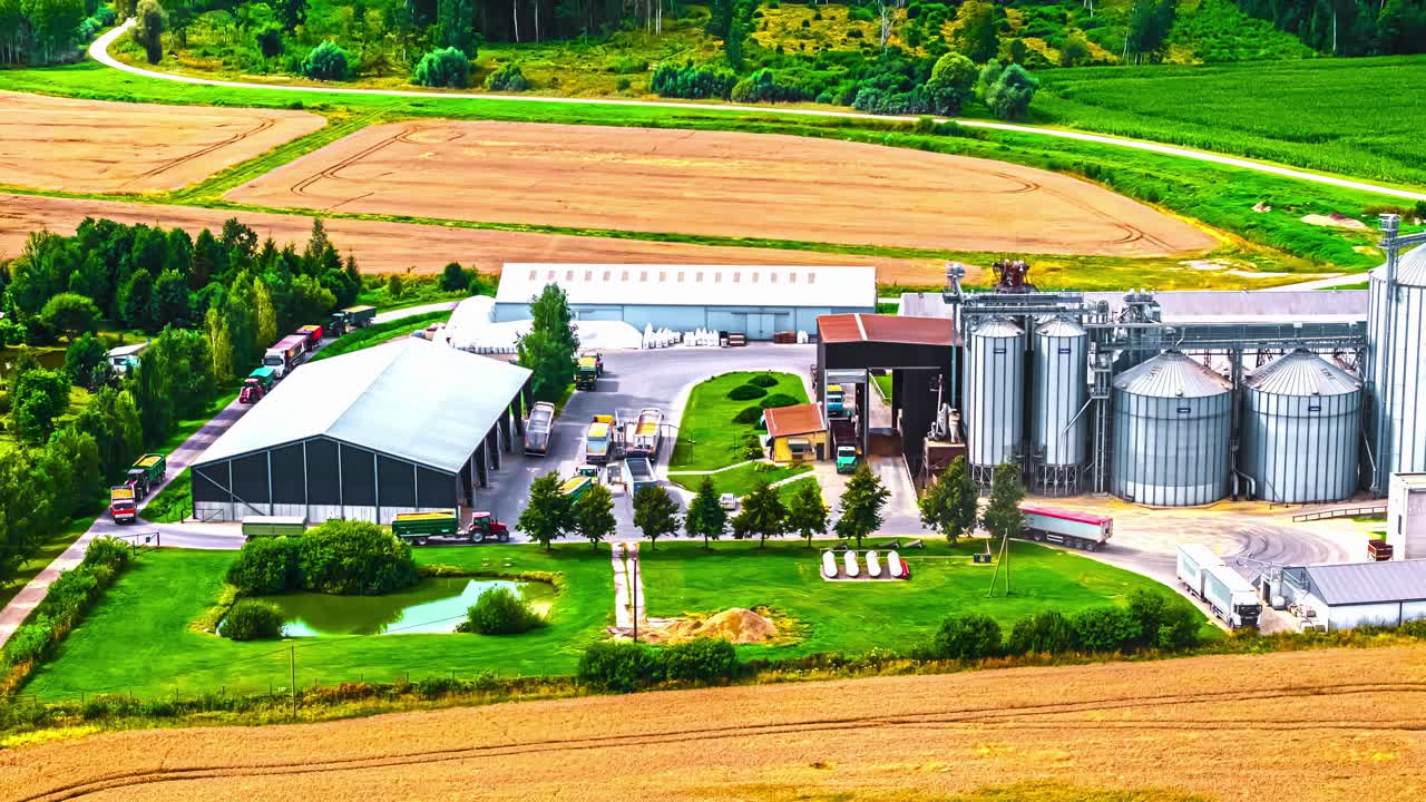 Timelapse of rural factory surrounded by vivid green fields in summer