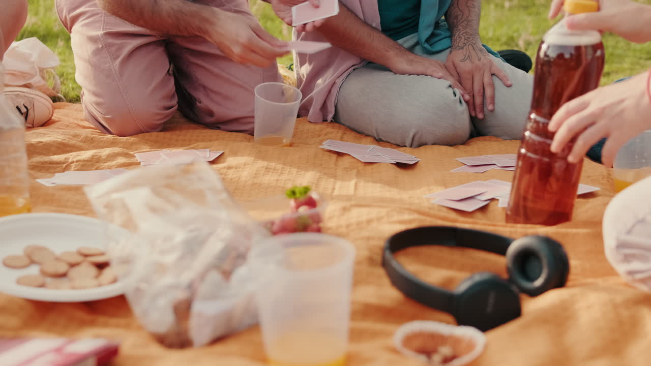Friends Playing Cards at a Picnic