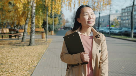 businesswoman walking in autumn park