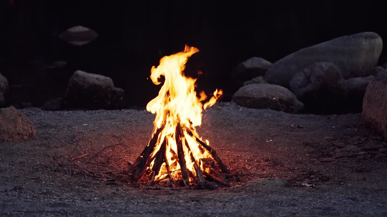 Big bonfire fire on nature background. Beautiful fire burns brightly. Slow motion