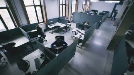 people working in a modern open-plan office from an overhead view