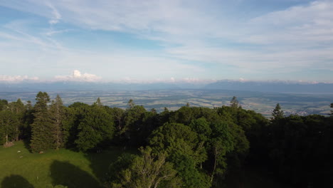 Slow-aerial-tilt-down-high-above-the-Swiss-countryside-in-Sainte-Croix,-Switzerland-on-a-sunny-day