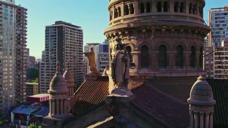 aerial view circling sacramentino church rooftop statues and ornate bell tower with surrounding high rise urban city landscape