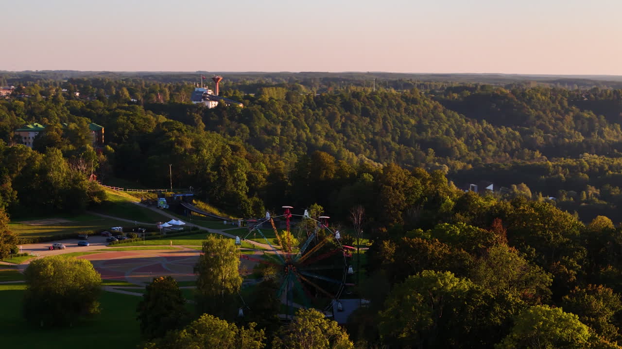 Aerial View of a Ferris Wheel in a Park at Sunset