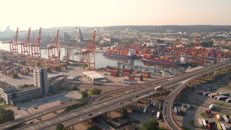 aerial port of gdansk - logistics, global trading, transport, shipping container terminal, poland at sunrise