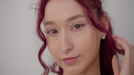 Close-Up-Image-Of-A-Woman-With-Red-Curly-Hair-And-Touching-It-With-Hand