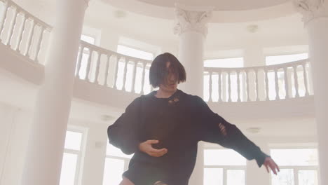 bottom view of contemporary male japanese dancer training dance moves in the middle of the studio 3