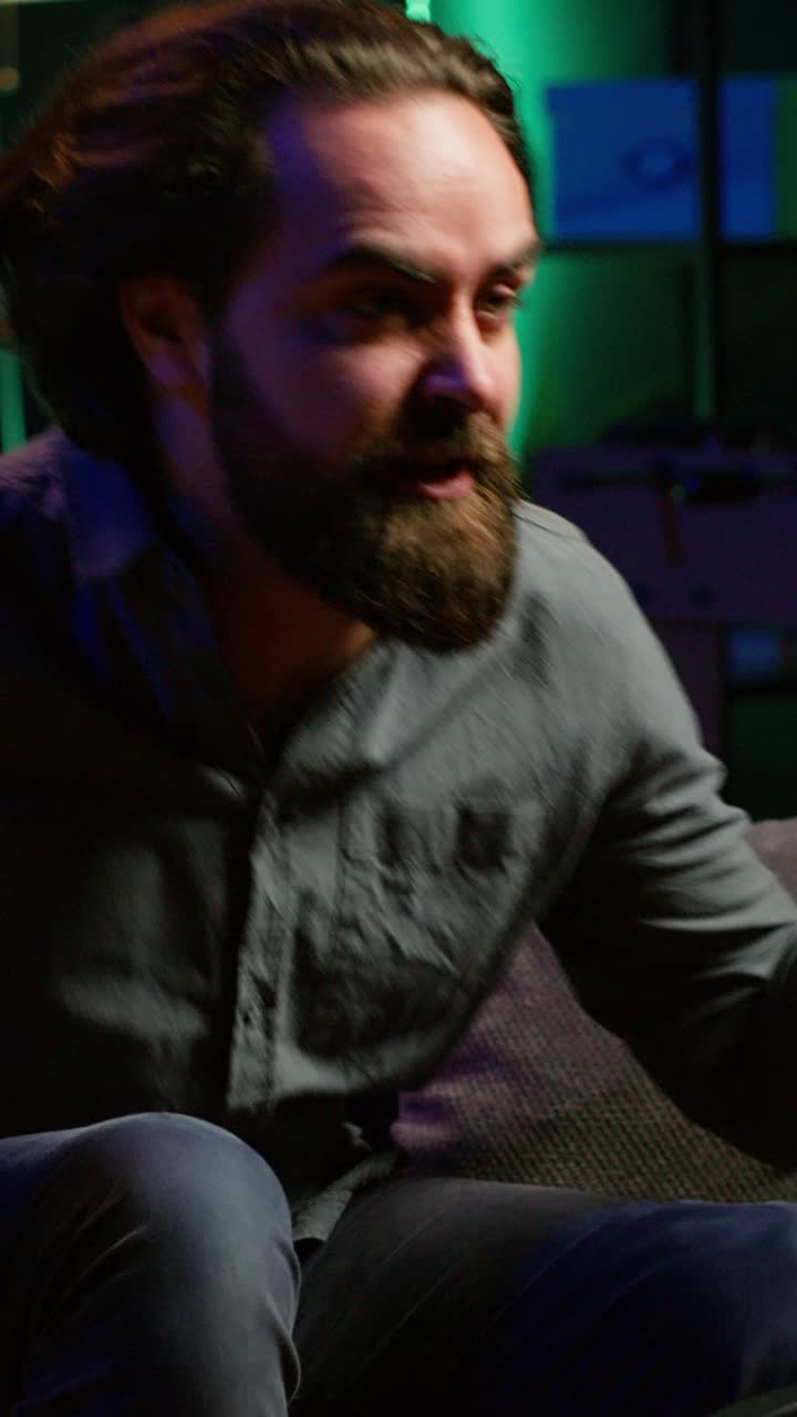 Vertical video Angry man looking at football competition on TV, outraged by events