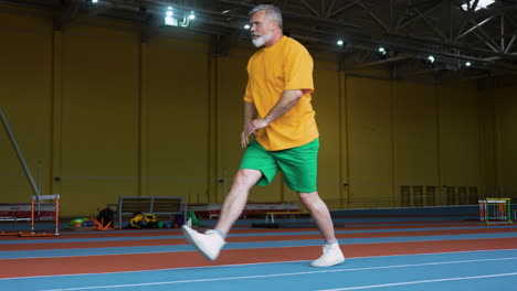 senior man stretching indoors