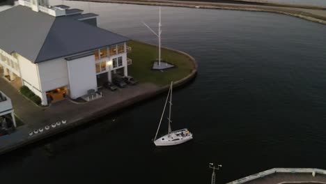 sailboat entering harbor after boating at lake pontchartrain in new orleans, louisiana, usa. - aerial orbit