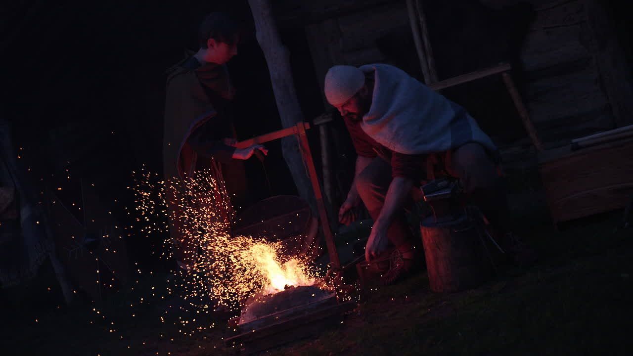 Medieval blacksmith scene at night