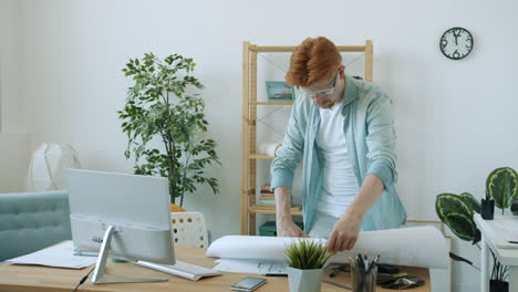 architect working on blueprints in a home office.