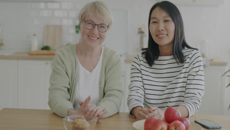 happy mother and daughter in kitchen