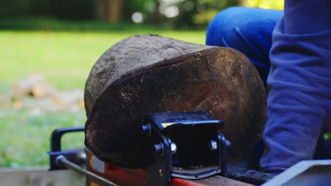 Close-up-of-man-using-log-splitting-machine-successfully