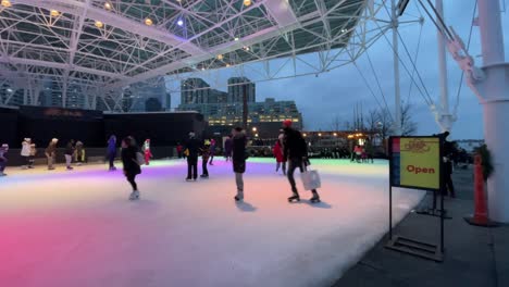 Night-Toronto-Harbourfront-skating-during-winter-evening---January-2022---Skating-in-urban-city-during-winter-in-Ontario,-Canada-on-new-years-near-waterfront