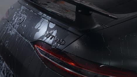 detailed black sports car with water spots
