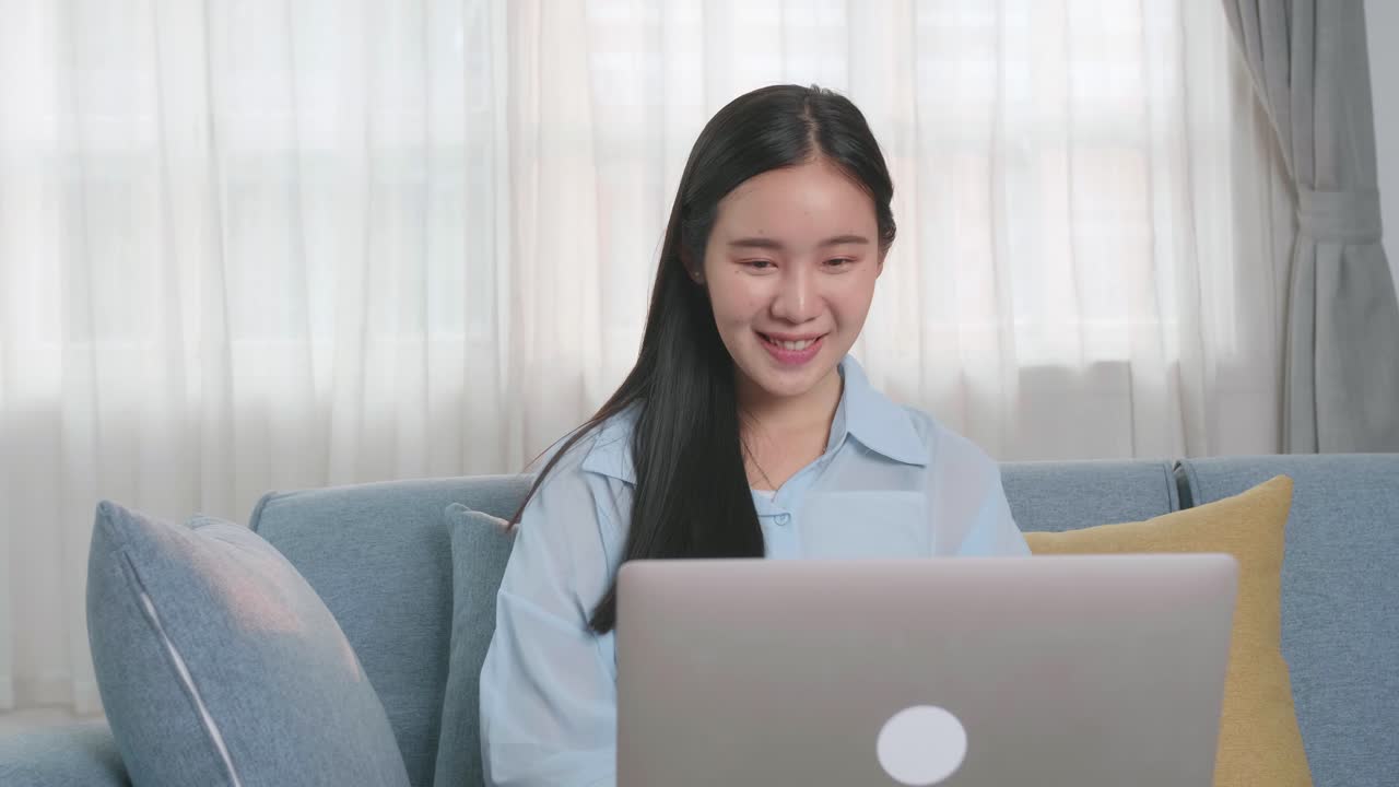 Asian Woman Sitting Sofa And Use Laptop Computer, Video In 4K