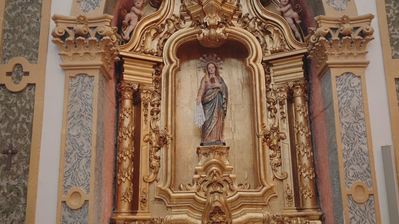 sacred statue of virgin mary displayed in golden altar within church interior
