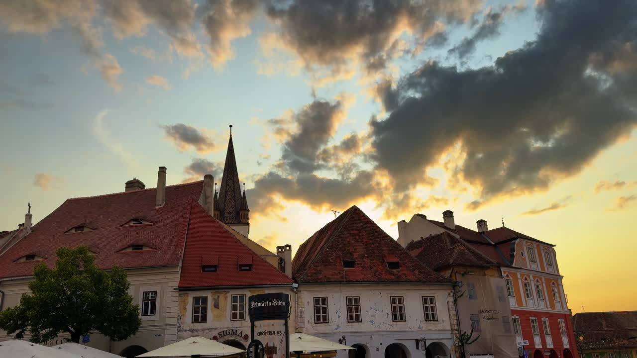 Sibiu, Romania, 1 July 2025: Sunset view over Sibiu old town. Old town houses with red rooftops at golden hour in Sibiu, Romania
